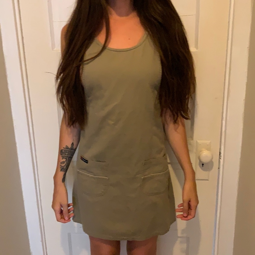 Dark green dress short. Pockets in front.